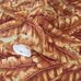 Фото рулона моющихся обоев Banana Leaf артикул 1507-4 из каталога Vera от Adawall  с детализацией фактурного растительного узора красно бордового цвета под ткань с золотым мерцанием