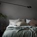 Интерьер скандинавской спальни декорированный фактурными обоями под ткань серого цвета Dim Linen из каталога LINEN