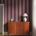 Цифровое панно для прихожей Stockholm Stripe Bordeaux, арт. 9792W от Borastapeter, классические полосатые обои в увеличенном масштабе. Полосы разной ширины четырех разных оттенков придают строгому ритму узора живость и представлены в бежевых и бордовых тонах с яркими синими акцентами. Эти полосатые обои идеально подойдут для детской, спальни, кухни или прихожей, создавая динамичную атмосферу. Заказать их можно в интернет-магазине ODesign с бесплатной доставкой по всей России.