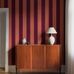 Цифровое панно для прихожей Bjärö Stripe Orange&Bordeaux, арт. 9798W от Borastapeter, — это смелые графические обои с широкими полосами — классика с изюминкой в приглушенном кирпично-красном и насыщенным бордовым — элегантная, сдержанная цветовая палитра. Эти полосатые обои идеально подойдут для детской, спальни, кухни или прихожей, создавая динамичную атмосферу. Заказать их можно в интернет-магазине ODesign с бесплатной доставкой по всей России.