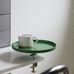 Фрагмент кофейного столика на фоне обоев арт. 38606  из коллекции "Borosan EasyUp® 2020" от Borastapeter, Швеция с мелким растительным рисунком зеленого цвета на белом фоне