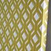 Фото обоев в перспективе арт. PDG1053/04  из коллекции Mandora от Designers Guild, Великобритания с современным геометрическим рисунком желто-горчичного цвета на сером фоне в шоу-руме  Одизайн, большой ассортимент