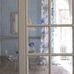 Фрагмент интерьера гостиной с обоями арт. PDG650/02  из коллекции Shanghai Garden от Designers Guild, Великобритания с рисунокм из мелкого состаренного орнамента в лазурном цвете, с доставкой до дома