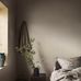 Интерьер мансардной спальни с шведскими обоями в классическую полоску на фоне льняной ткани.